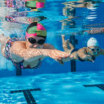 Competitive swimmers underwater photo featured image