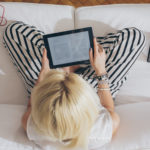 Blonde Woman Reading an E-Book on Her Tablet featured image