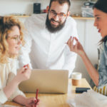 Coworkers collaborating over workspace featured image