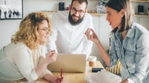 Coworkers collaborating over workspace featured image