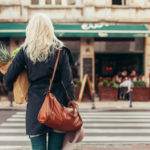 Woman with groceries crossing the street featured image