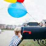 little boy looking in mailbox featured image