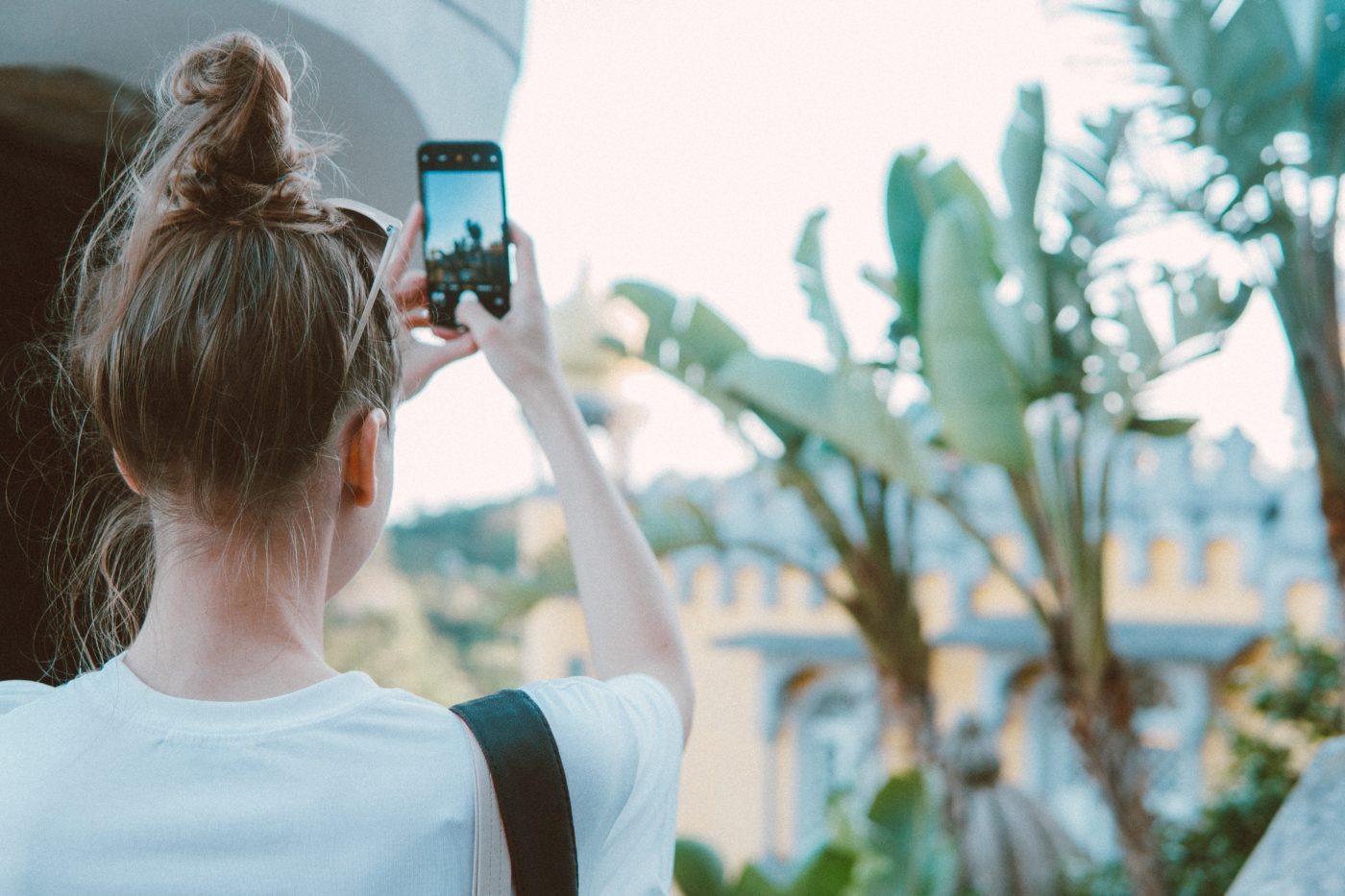 Girl taking photos with her iphone featured image