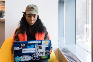 Computer developer girl working by the window featured image